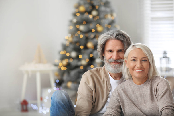 Happy mature couple celebrating Christmas at home - Fotografie, Obrázek