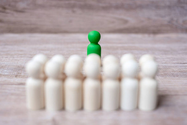 Green leader businessman with crowd of wooden men. leadership, b - Photo, Image