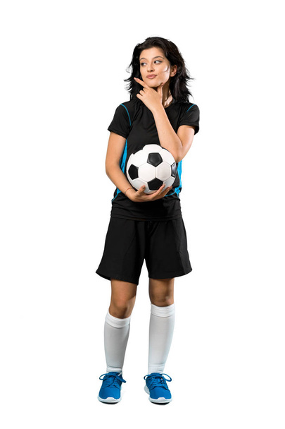 A full-length shot of a Young football player woman thinking an idea over isolated white background - Фото, зображення
