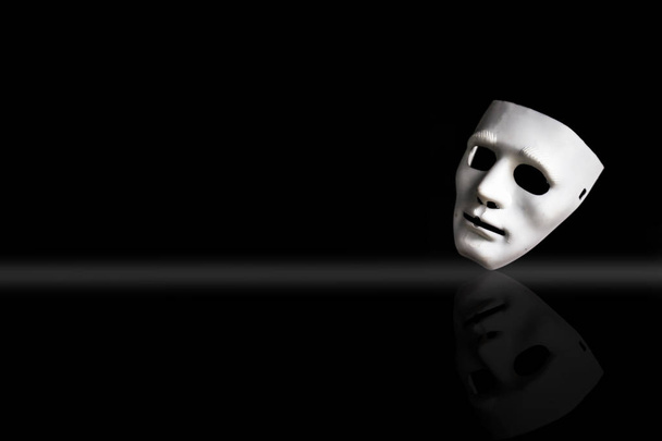 White-colored plastic face mask on black background  - Foto, Imagen