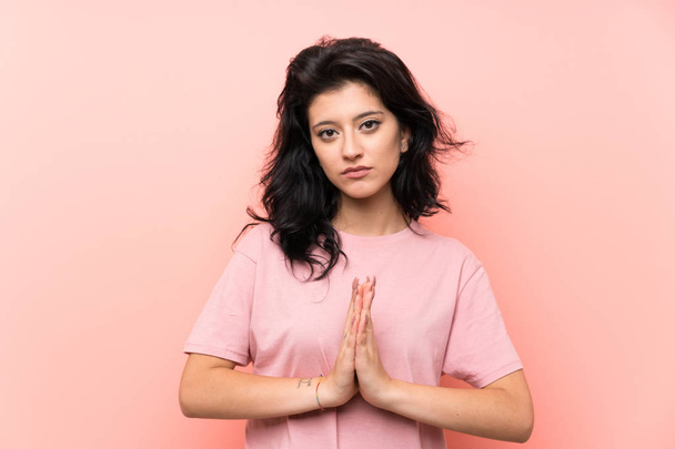 Young woman over isolated pink background pleading - Photo, Image