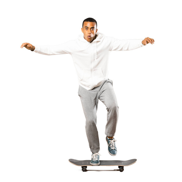 Full-length shot of Afro American skater man over isolated white - Photo, Image