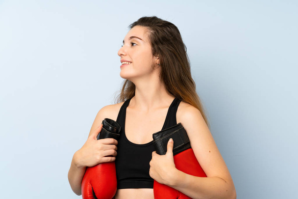 Young brunette girl with boxing gloves over isolated background - Fotoğraf, Görsel
