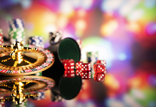 Casino theme.  Roulette, dice and poker chips on a colorful bokeh background. - Photo, Image