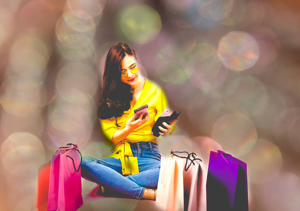 woman with smartphone & credit card swiping machine. shopping li - Valokuva, kuva