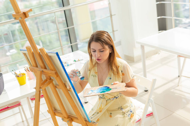 painting art classes. drawing courses. skills imagination and inspiration. Charming student girl creating picture on easel. - Photo, Image