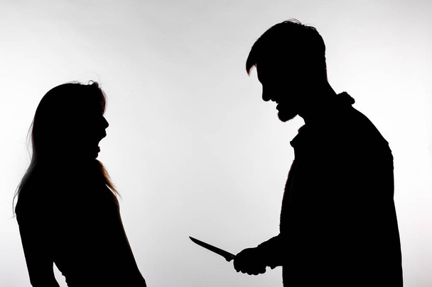 Aggression and abuse concept - man and woman expressing domestic violence in studio silhouette isolated on white background. - Fotó, kép