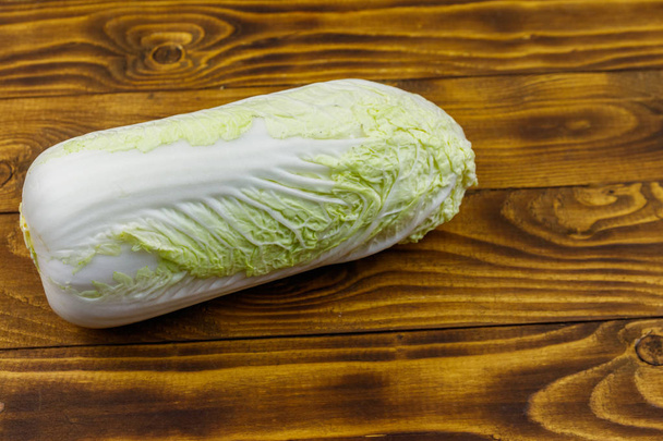 Whole chinese cabbage on wooden table - Фото, зображення