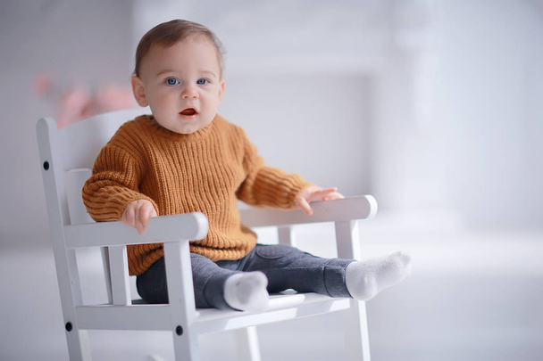 kid in a warm sweater child boy / portrait seasonal clothes, warm knitted sweater on a child, autumn portrait - Foto, Bild