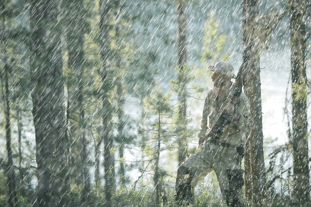 man goes hunting forest summer / landscape in the forest, huntsman with a hunting rifle hunts - Fotoğraf, Görsel