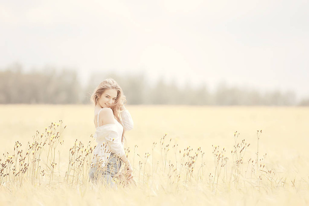 happy girl in autumn field with spikelets landscape / adult young girl portrait, summer look, nature - Fotografie, Obrázek