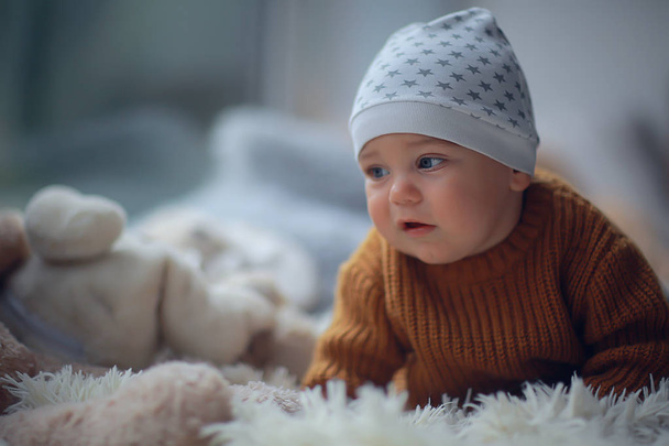 kid in a warm sweater child boy / portrait seasonal clothes, warm knitted sweater on a child, autumn portrait - Photo, Image
