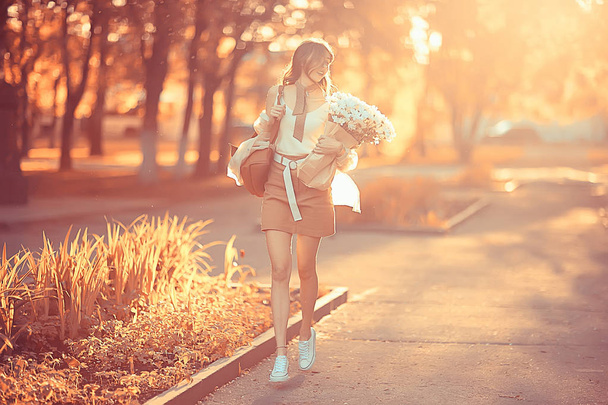 girl holding a bouquet of flowers a walk in the park / romantic young beautiful cute model, love feelings gift - Fotografie, Obrázek