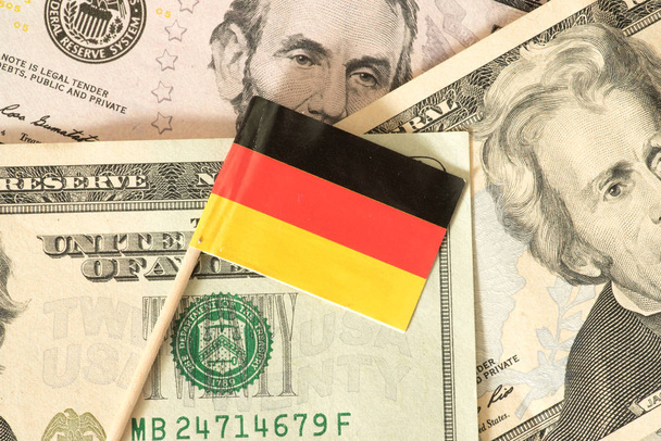 Flag of Germany and dollar bills in the background - Фото, зображення