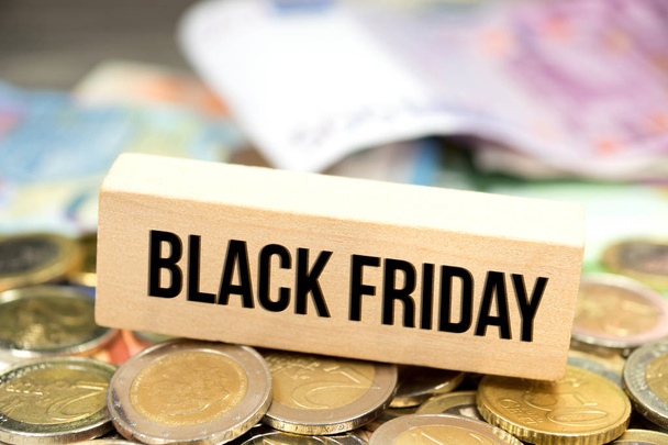 Euro banknotes and coins and a reference to the special offers on Black Friday - Photo, Image