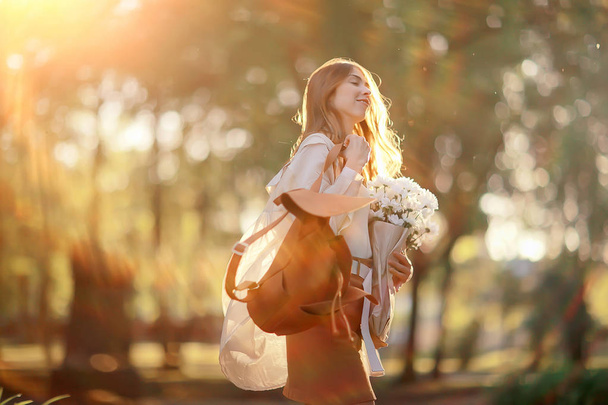 girl holding a bouquet of flowers a walk in the park / romantic young beautiful cute model, love feelings gift - Fotoğraf, Görsel
