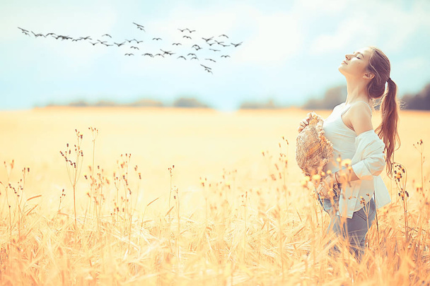 happy girl in autumn field with spikelets landscape / adult young girl portrait, summer look, nature - Foto, Imagen