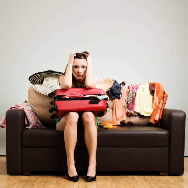 Young woman packing a travel bag on the plane before going on ho - Photo, image