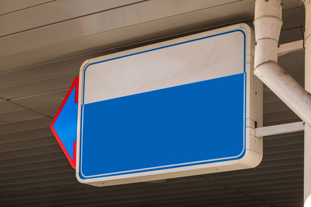 Close-up of blank white and blue sign with pointer on left - Foto, Imagen