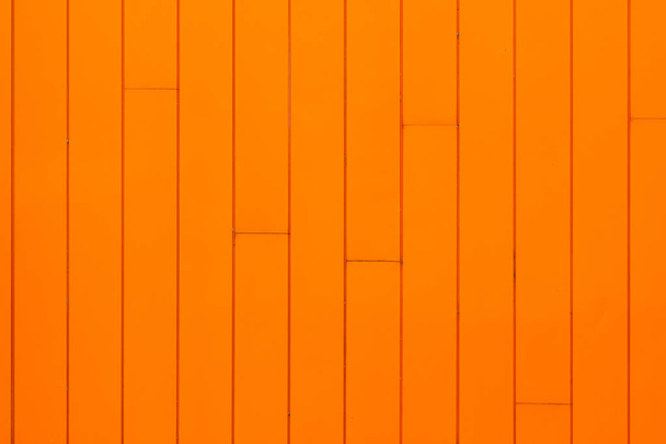 Bright orange building facade, painted wooden panels on wall. - Фото, изображение