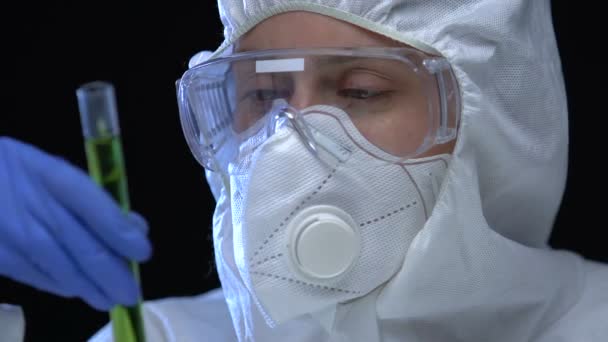 Researcher showing radioactive liquid sample in tube, mass destruction weapon - Filmagem, Vídeo