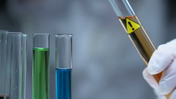 Scientist adding potentially dangerous substance in tube, examining properties - Video, Çekim