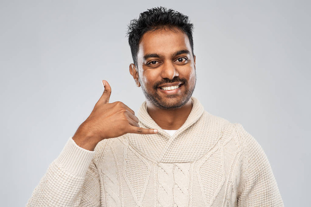 indian man in knitted sweater over gray background - Foto, Imagem
