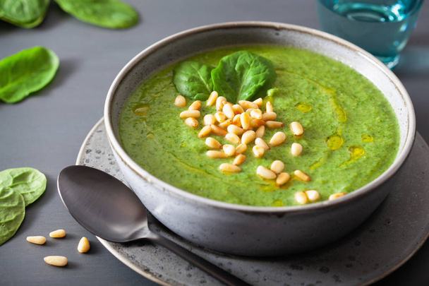green creamy cauliflower spinach soup on gray background - Фото, изображение