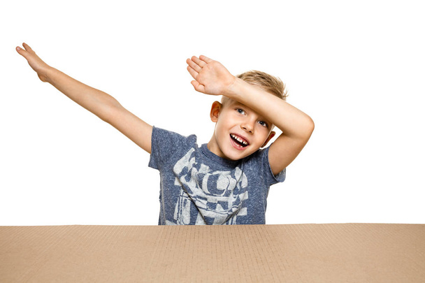 Cute little boy opening the biggest postal package - Photo, image