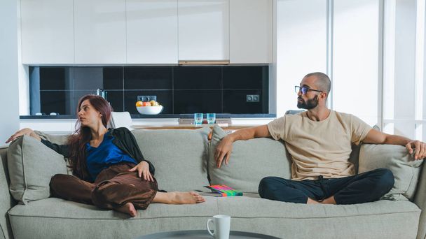 Millennial couple in love relaxing together on sofa at home.  - Photo, Image