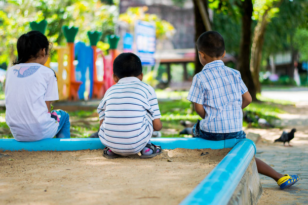 backview friends child sitting in playground - Foto, Bild