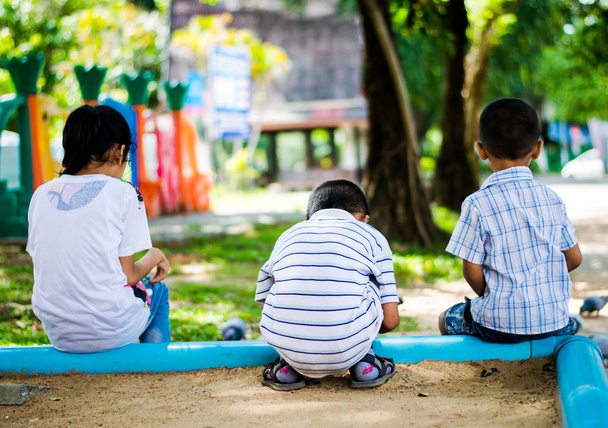 backview friends child sitting in playground - Foto, Imagem