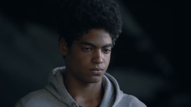 Unhappy afro-american teenager looking camera, poverty crisis, hopelessness - Πλάνα, βίντεο