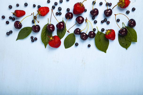 Blueberries, cherries and strawberries close-up. - Фото, изображение