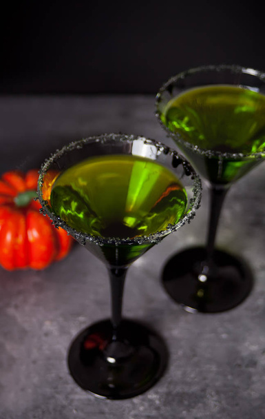 Two glasses with green zombie cocktail for Halloween party on the dark background - Valokuva, kuva