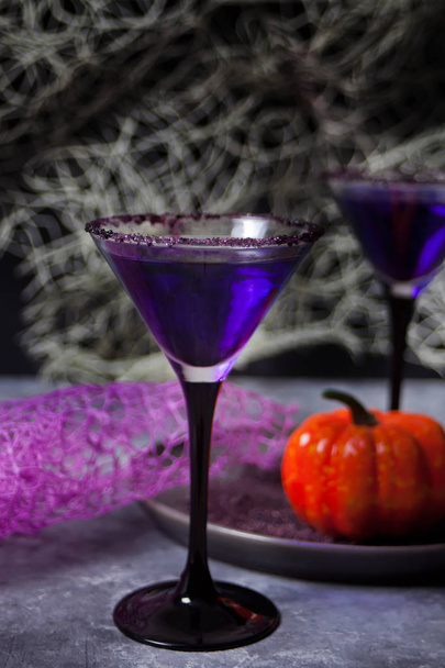 Two glasses with purple cocktail for Halloween party on the dark background - Фото, зображення