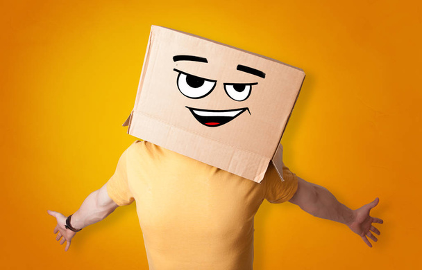 Young man with cardboard box on his head - Photo, Image