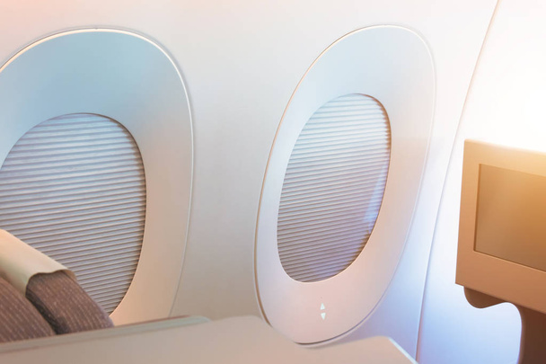 Portholes with the curtain down for sun protection during the flight for the passenger of the aircraft. - Photo, Image