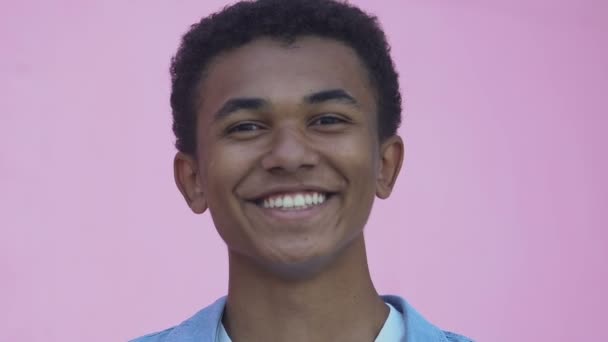Close-up of Afro-American teen boy smiling and flirting at camera, popularity - Video