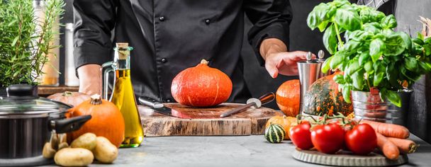 cropped shot of male chef preparing fresh vegetables and ingredients on table - Zdjęcie, obraz