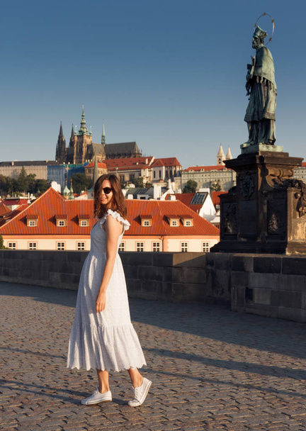 A girl walks around Prague on a sunny day. - Fotó, kép