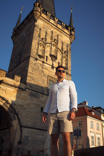 A man walks around Prague on a sunny day. - Фото, зображення