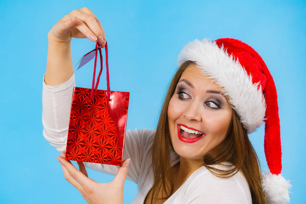 Happy Christmas woman holds gift bag - Foto, imagen