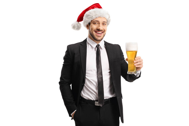 Businessman wearing a Santa Christmas hat and holding a glass of - Foto, imagen