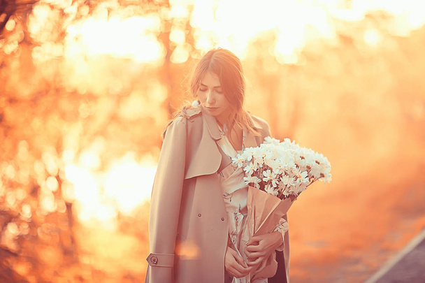 girl holding a bouquet of flowers a walk in the park / romantic young beautiful cute model, love feelings gift - Φωτογραφία, εικόνα