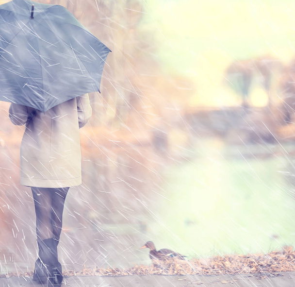 herfst regendruppels model/regen weer, meisje herfst look, spatten en regendruppels in de wind, oktober in de stad - Foto, afbeelding