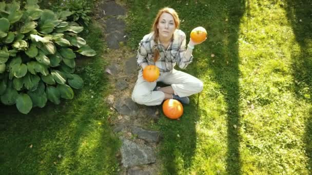 Halloween girl. Girl play with pumpkins and treat. Surprised woman with Halloween Pumpkin - Footage, Video