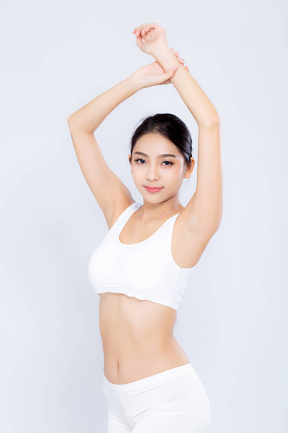 Attractive Young Asian Woman In Sports Bras Applying Moisturizer