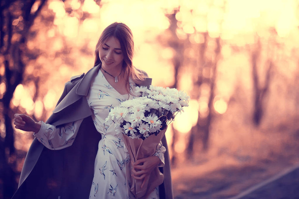 girl holding a bouquet of flowers a walk in the park / romantic young beautiful cute model, love feelings gift - Photo, Image