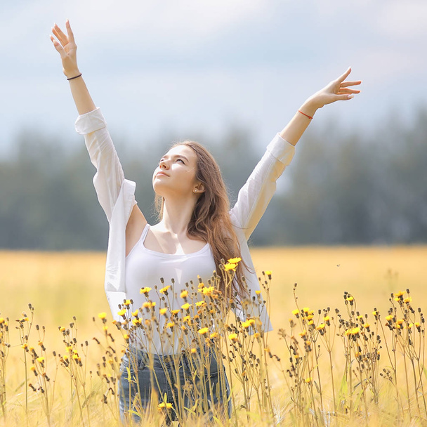happy girl in autumn field with spikelets landscape / adult young girl portrait, summer look, nature - Φωτογραφία, εικόνα